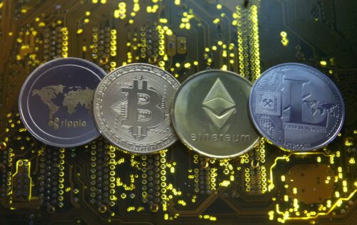 FILE PHOTO: Representations of the Ripple, Bitcoin, Etherum and Litecoin virtual currencies are seen on a PC motherboard in this illustration picture, February 14, 2018. REUTERS/Dado Ruvic/Illustration